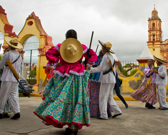 Men and women in costume dancing outside