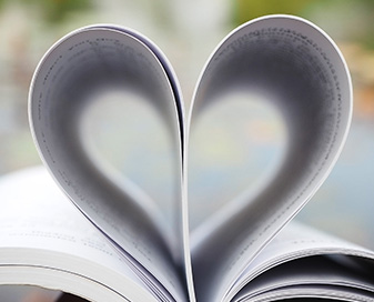 Book opened with pages in the shape of a heart